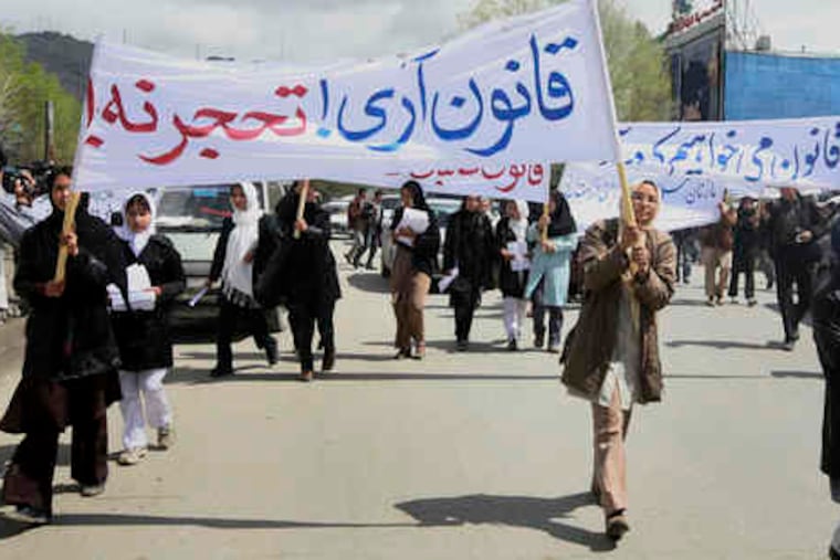 Demonstrators, mostly young women, marched in Kabul yesterday against a conservative law, signed last month, that they say legalizes marital rape. They were met with a larger protest.
