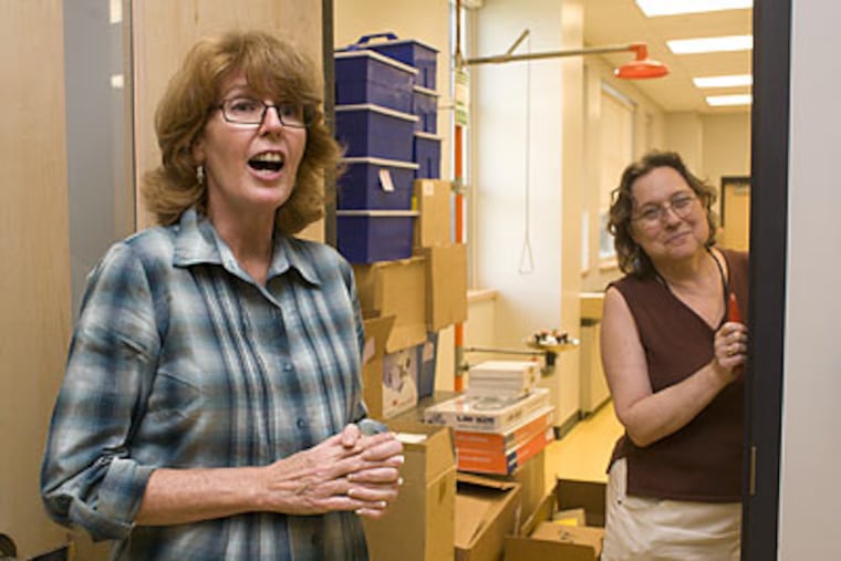 In a science lab at the new Lincoln High School in Northeast Philadelphia, the school district’s Peg Monahan (left) and Anita Brook Dupree check to see that all necessary equipment is on site. (Ed Hille/Staff Photographer)