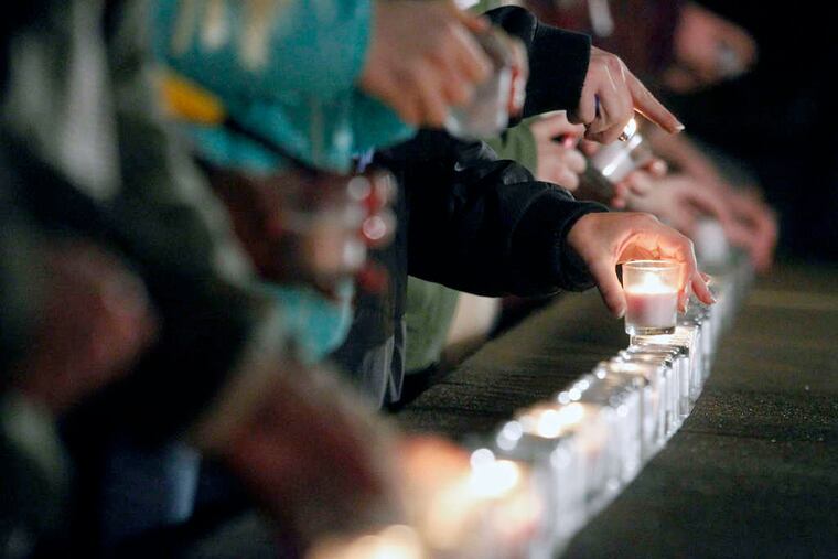 Students light candles during a Dec. 5 vigil in Charlottesville, Va., in support of sexual-assault victims.