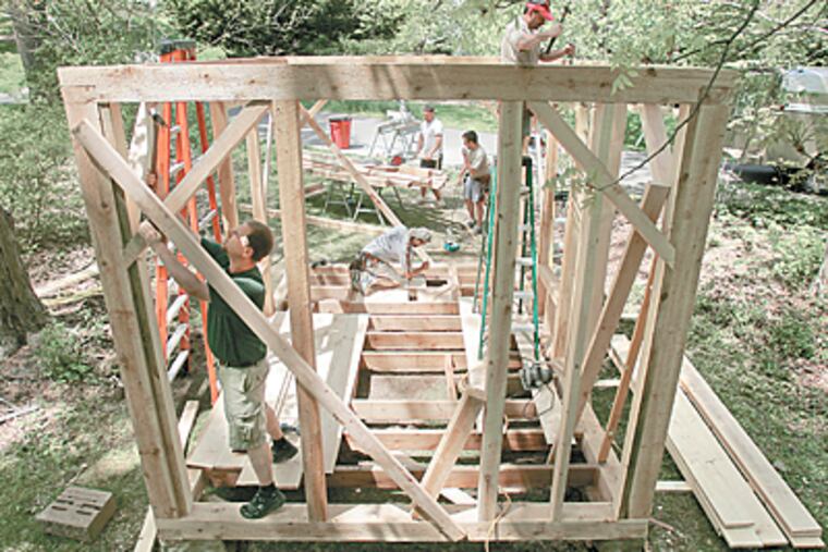 Carpenters from Pine Street Carpenters of West Chester build a replica of Thoreau's Walden Pond cabin at Tyler Arboretum in Media. (Barbara L. Johnston / Inquirer)