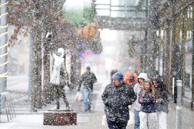 Heavy snow falls along Nicollet Mall on Sunday in Minneapolis