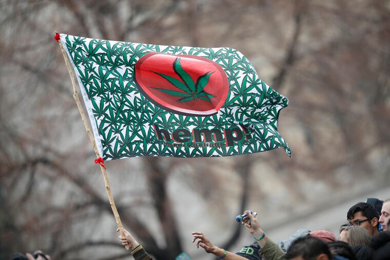 In this April 20, 2018 file photo an attendee hoists a hemp flag during the Mile High 420 Festival in Denver.(AP Photo/David Zalubowski, File)