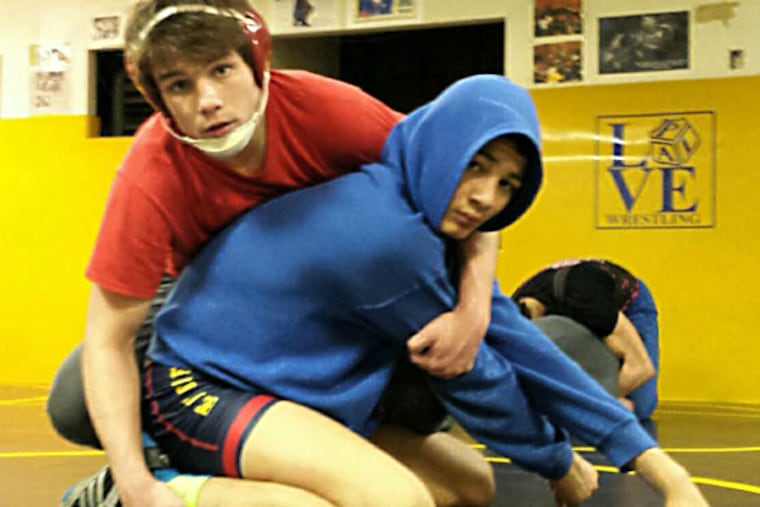St. Joseph's Prep senior Bobby Endy (top) works out with seventh grader Angel Garcia at the Rizzo PAL in Port Richmond. The unbeaten 152-pounder is seeking a state title. (Ed Schneider)