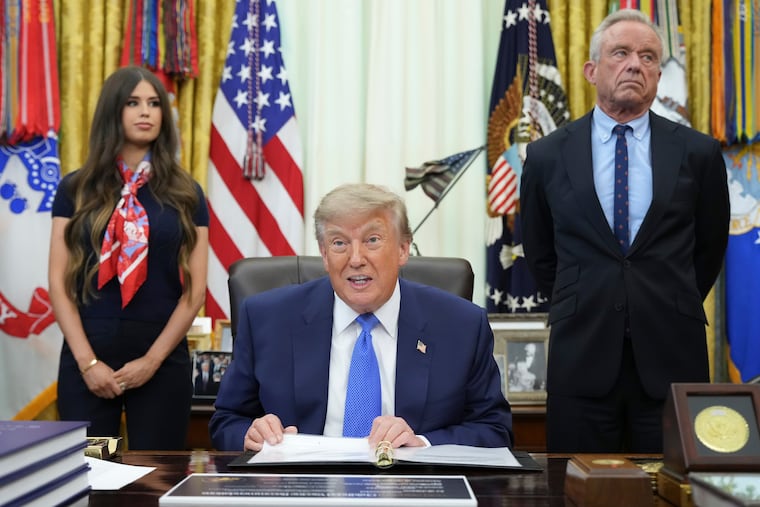 President Donald Trump speaks as Health and Human Services Secretary Robert F. Kennedy Jr. (right) and Jayme Franklin listen during a meeting to sign an executive order about vaccines on Monday in the Oval Office of the White House.