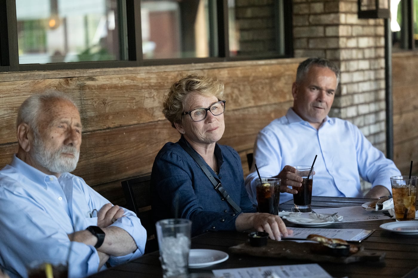 U.S. Rep. Chrissy Houlahan (D., Pa.) sits between her father, Andy Jampoler, and her husband, Bart Houlahan, at Brick & Brew in Malvern. Houlahan's parents recently moved in with her. 