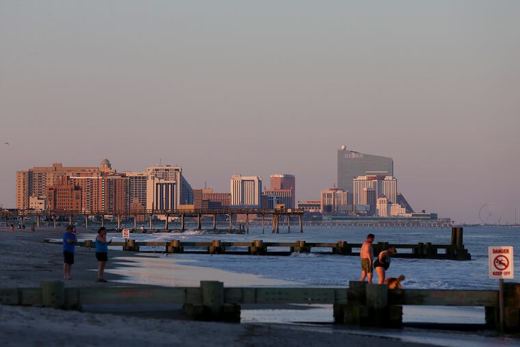 Atlantic City skyline looms in the distance as seen from the beach in Margate City, N.J.