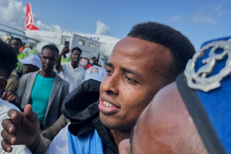 Referee Omar Artan, who was denied entry to the United States, is welcomed by supporters Wednesday upon his arrival in Mogadishu, Somalia.