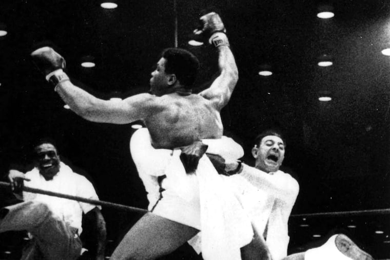 Muhammad Ali, then known as Cassius Clay, is lifted by a handler after winning the heavyweight title from Sonny Liston in 1964.