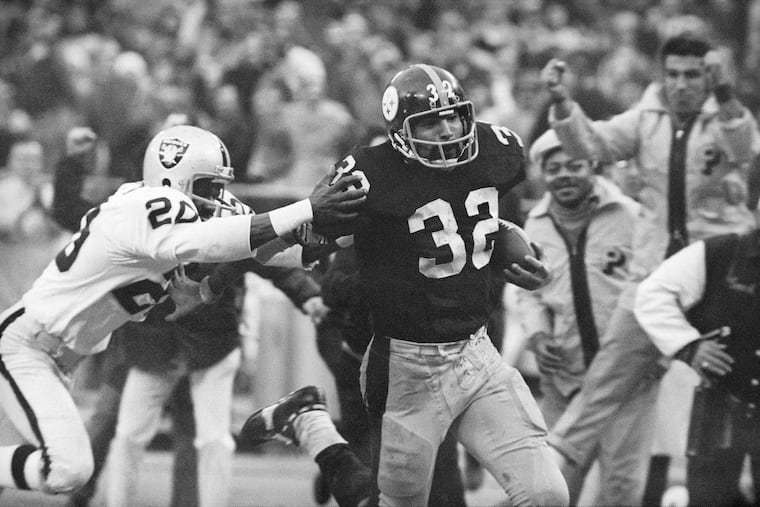Steelers running back Franco Harris (32) eludes a tackle by the Raiders' Jimmy Warren as he runs 42 yards for a touchdown after catching a deflected pass forever known as the "Immaculate Reception" in an NFL playoff game on Dec. 23, 1972.