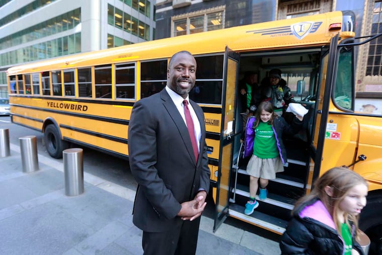 Marcus Allen, CEO Big Brothers Big Sisters of Southeastern Pennsylvania greets children leaving a bus.