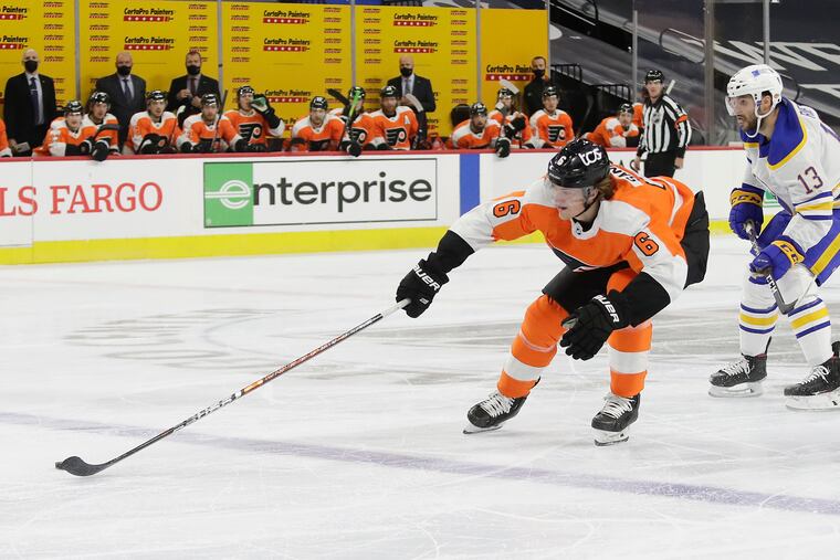 Flyers defenseman Travis Sanheim reaches for the puck against Buffalo Sabres left winger Tobias Rieder on Monday. Sanheim was moved to the top pairing in the third period in that game. He started Tuesday's game on the No. 1 pairing.