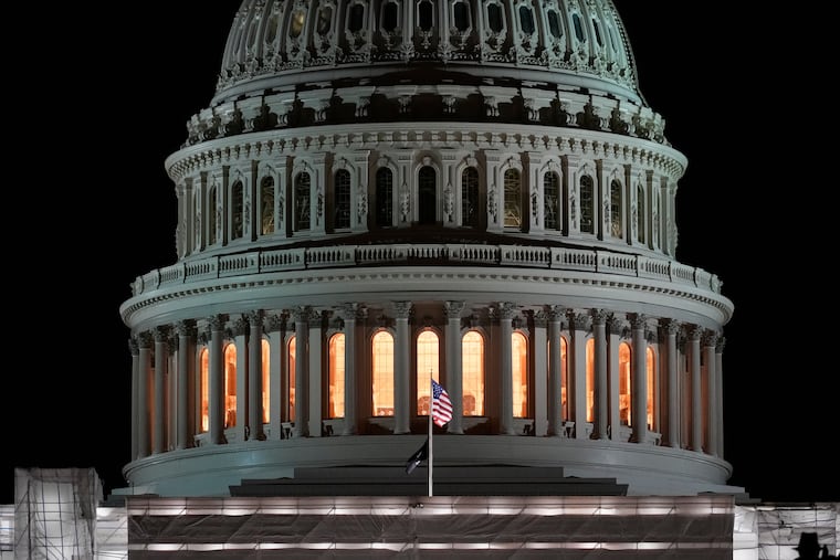 The American flags flies on the U.S. Capitol before sunrise on the the second year anniversary of the violent insurrection by supporters of then-President Donald Trump, in Washington, Friday, Jan. 6, 2023.