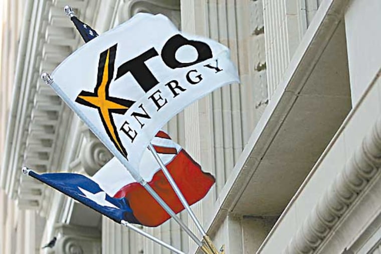FILE - In this Nov. 3, 2005 file photo, an XTO Energy flag adorns the new Bob R. Simpson Building, in Fort Worth Texas. Exxon Mobil will buy XTO Energy in an all-stock deal worth $31 billion as the oil giant moved aggressively Monday, Dec. 14, 2009, to capitalize on the growing supply of natural gas at home. (AP Photo/Fort Worth Star-Telegram, Ron Jenkins, file)
