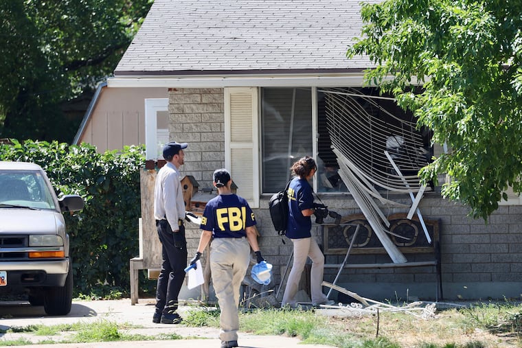 Law enforcement investigate the scene of a shooting involving the FBI on Wednesday in Provo, Utah. A man accused of making threats against President Joe Biden was shot and killed by FBI agents hours before the president was expected to land in the state Wednesday, authorities said.