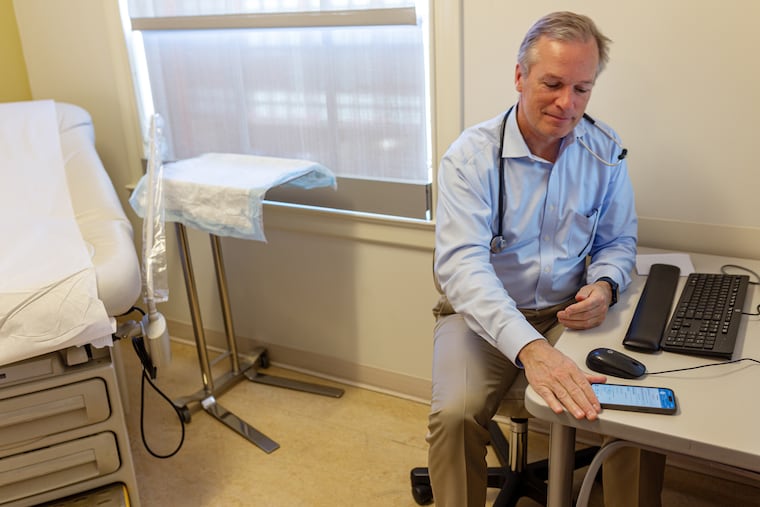 Stanford Health Care's Christopher Sharp uses an ambient AI scribe on his phone to take notes during patient visits. MUST CREDIT: Geoffrey A. Fowler/The Washington Post