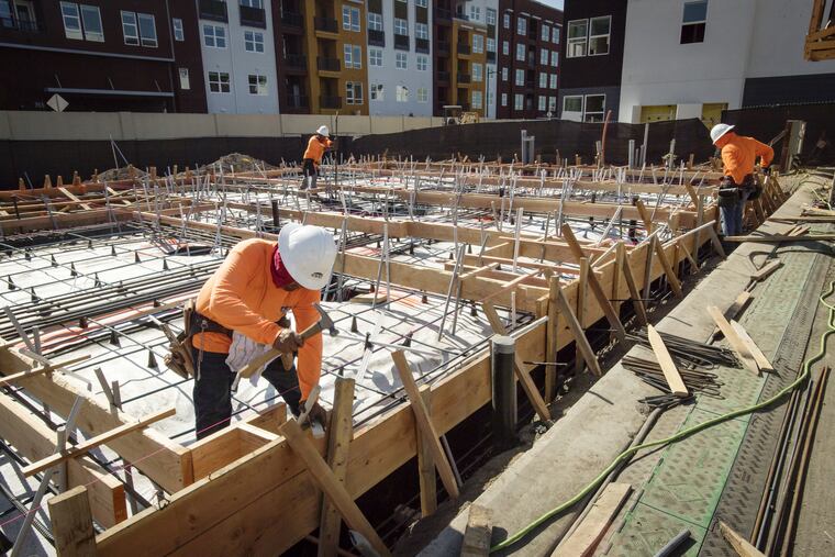 Contractors work on townhouses under construction in Milpitas, Cal., in October.