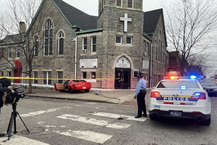 The red Ford Mustang the gunman was driving while being pursued by Philadelphia police near the intersection of Somerset and Ruth Streets in Kensington. After crashing the car, the 39-year-old man got out and ran and fired a gun at an officer who returned fire, killing him, police said.