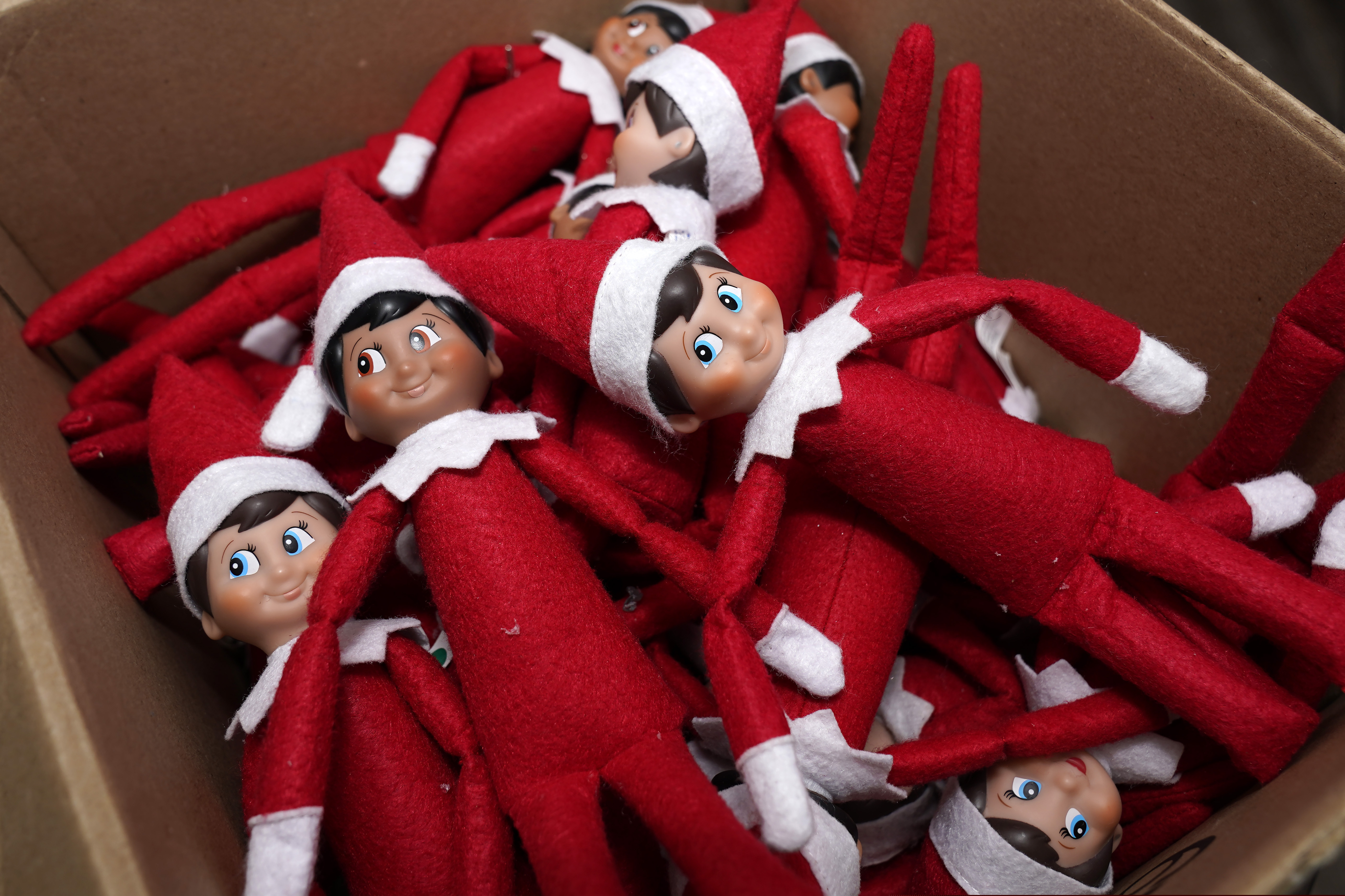 Elf on the Shelf figurines are piled in a box at a manufacturer's Atlanta studio in August 2020.