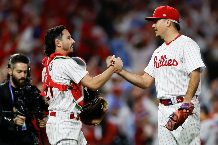 Catcher Garrett Stubbs and pitcher Orion Kerkering celebrate the Phillies' win in Game 2 of the NLCS on Tuesday. It was the first time Stubbs played this postseason.