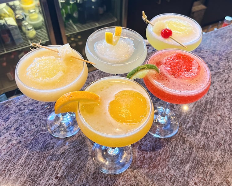 A line up of water ice martinis made with Pop's Homemade Italian Ice at Popi's Restaurant. Clockwise from left to right: The Pineapple Pizzaz, Limoncellotini, Piña Colada, Strawberry Daquiri, and The Gritty.