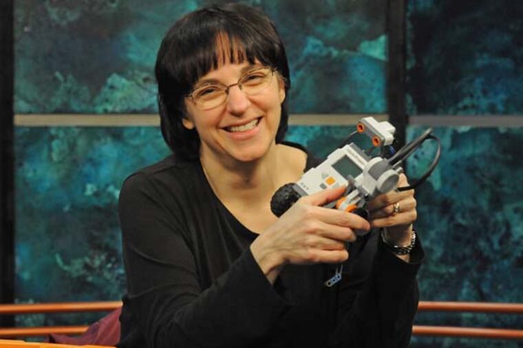 Jennifer Kay, a Rowan professor who has received Google grants for a series of workshops teaching high school teachers about robotics, with her Lego robots at Rowan on Jan. 2, 2014 . ( APRIL SAUL / Staff )