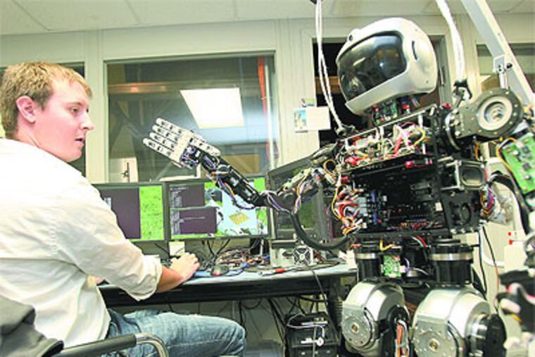 Engineers at Drexel and several other colleges are working on creating a special kind of robot for a Pentagon-sponsored competition that can drive a vehicle, climb over rubble and punch through a wall. (Charles Fox / Staff Photographer)