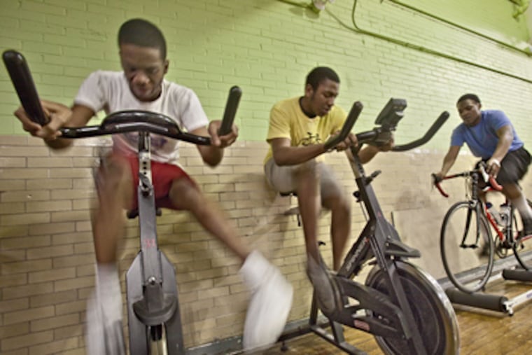 Cadence Cycling Foundation riders (from left) Eric Godwin, LeRoy Hayes, and Festus Aigbokhai. Hayes has lost more than 100 pounds and excelled academically. (David M Warren / Staff Photographer)