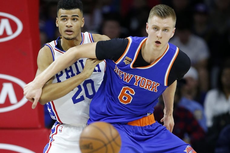 New York’s Kristaps Porzingis is guarded by the Sixers’ Timothe Luwawu-Cabarrot in a January game.
