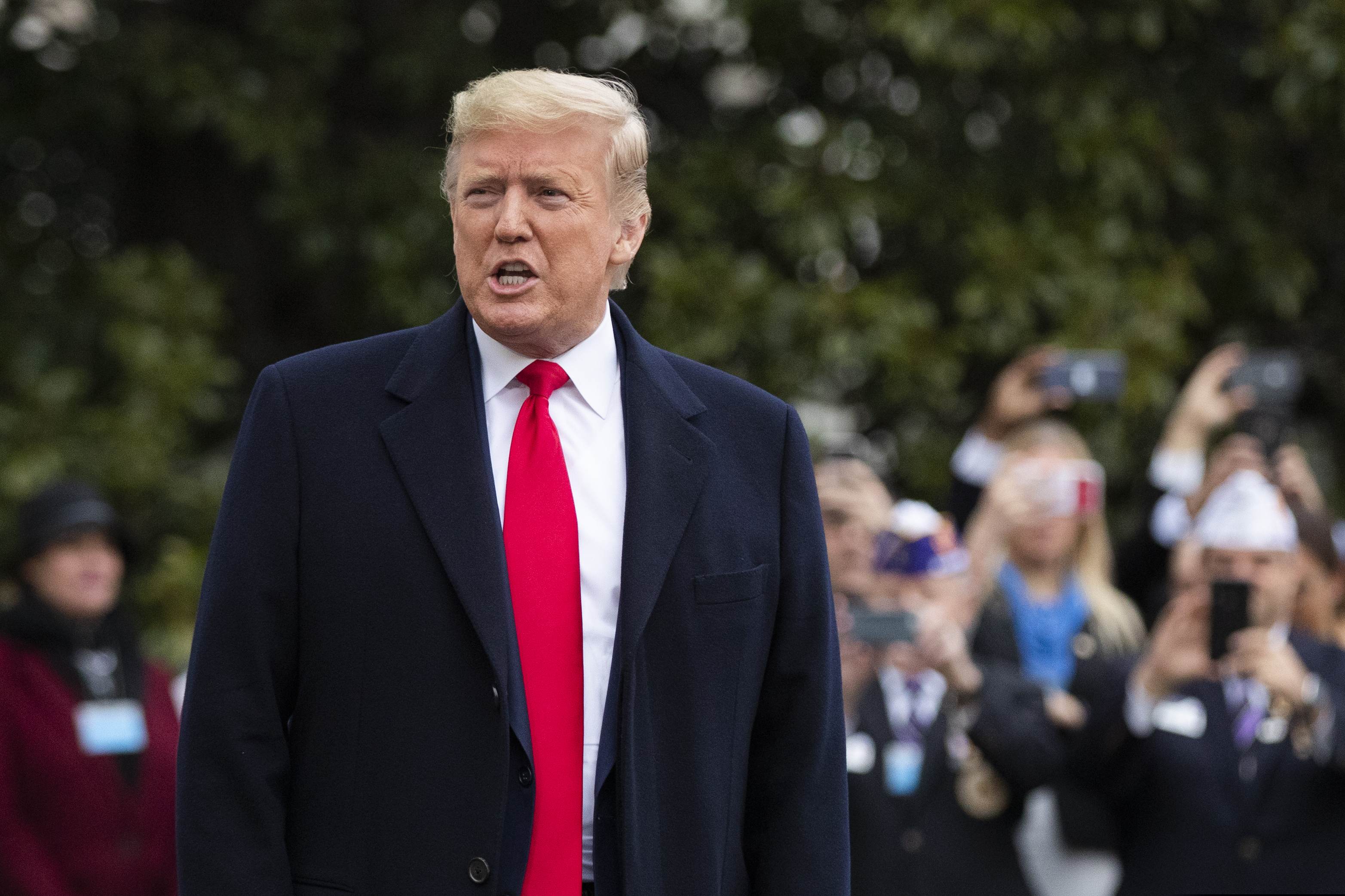 President Donald Trump speaks to the members of the media before leaving the White House, Monday, Jan. 13, 2020, in Washington, for a trip to watch the College Football Playoff national championship game between LSU and Clemson in New Orleans.