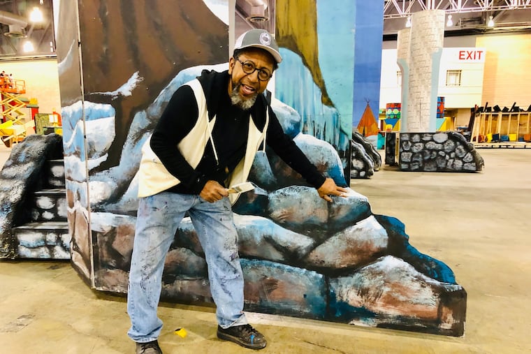 African American artist James Dupree shows off scenery he painted for Bill McIntyre's Shooting Stars Fancy Brigade. The club's New Year's Day performance took third place.