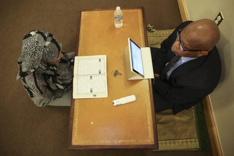Imam Anas Muhaimin instructs student Chevonne Byas at the Quba Institute in West Philadelphia.