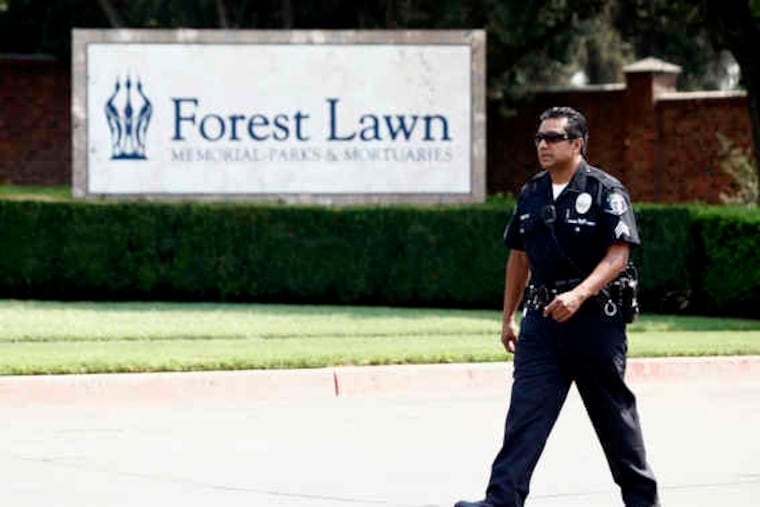 A police officer patrols the perimeter of the Forest Lawn Glendale cemetery, where Michael Jackson was to be entombed last night. Jackson died June 25 as he planned a comeback tour.