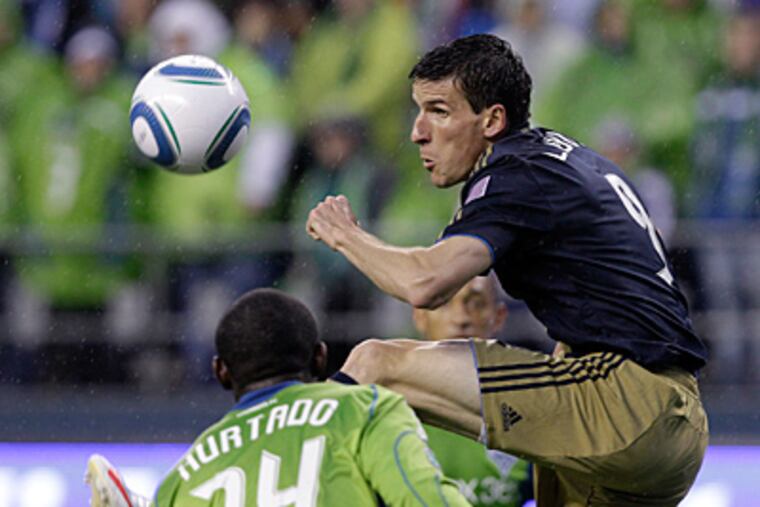 Union's Sebastien Le Toux, right, suffered a knee injury during Tuesday's game in New York. (AP Photo/Elaine Thompson)