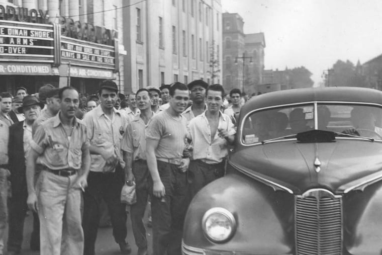 Workers rush a car in hopes of getting a ride to the Navy Yard during the Philadelphia transit strike in 1944.