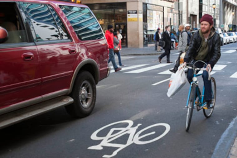 Bike rider on 15th St. approaching Sansom St., Philadelphia, April 2, 2012. ( David M Warren / Staff Photographer )