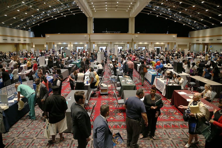 People talk to employers during a job fair at the Pennsylvania Convention Center in Center City Philadelphia on Thursday, July 25, 2019. Conference organizers are canceling events as the new coronavirus spreads across the country, including in the Philadelphia regon.