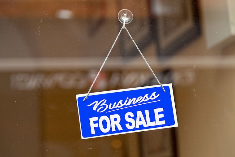 A "for sale" sign hangs in the window of a small business. Sales of businesses are picking up, according to the quarterly Insight Report from BizBuySell.