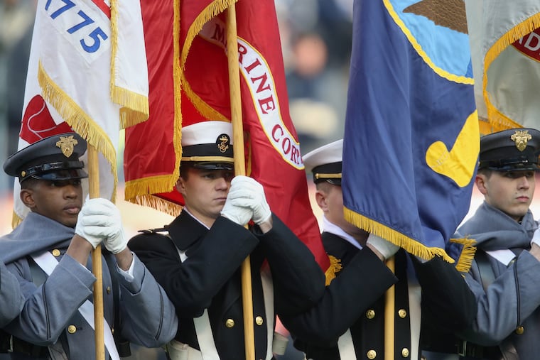 Army and Navy color guard members stand before the 119th Army-Navy game at Lincoln Financial Field in 2018. This year's game takes place Saturday.