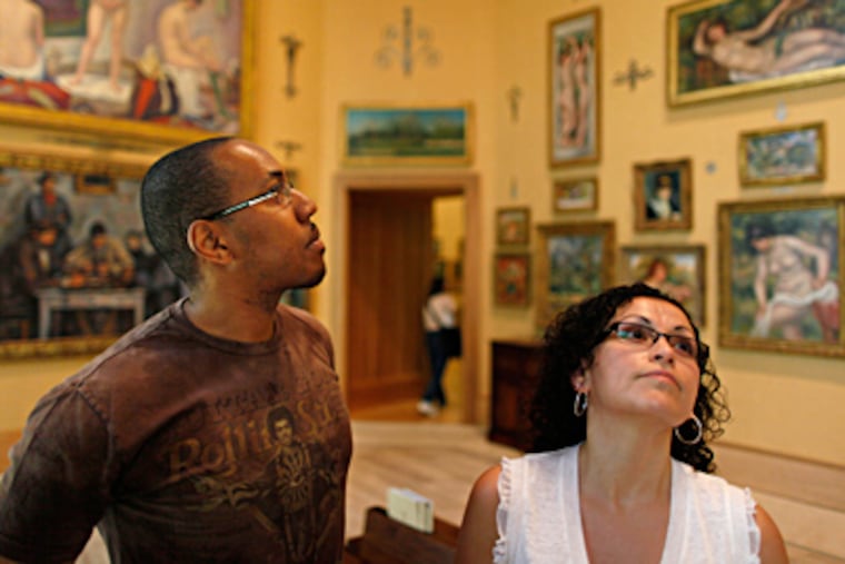 For Barnes' opening, a small number of reserved tickets were allotted, but officials also decided to treat some to free passes. In the main gallery are Ambrose Crenshaw and Saudy Carrera. MICHAEL S. WIRTZ / Staff Photographer