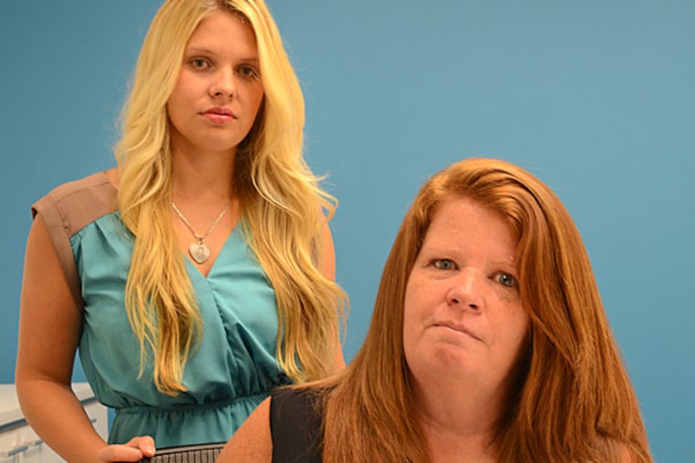 Peg Keeley and daughter Lauren Mazza wear necklaces with a photo of Mark Keeley, Peg’s son and Lauren's brother. The family will receive nothing from a PUC settlement. TOM GRALISH / Staff Photographer