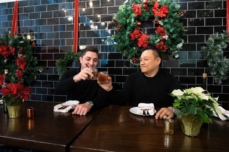 Derek Gibbons (left) and Tim Lu making a toast at their now-closed Italian restaurant Figo in Northern Liberties in 2022. Lu and Gibbons have since split from their business partnership.