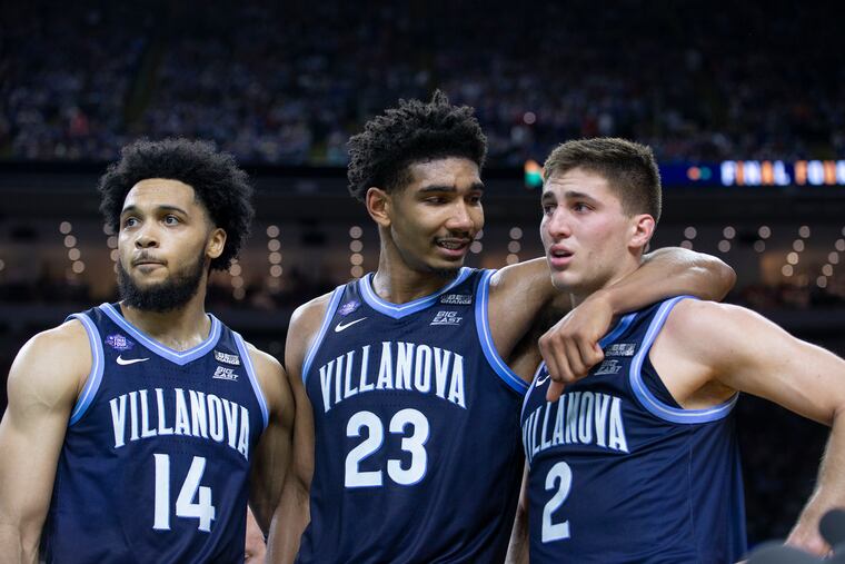 L-R: Caleb Daniels, Jermaine Samuels, and Collin Gillespiie of Villanova in the final moments of their loss to Kansas in the national semifinal game of the NCAA Tournament on April 2, 2022 at the Superdome in New Orleans.