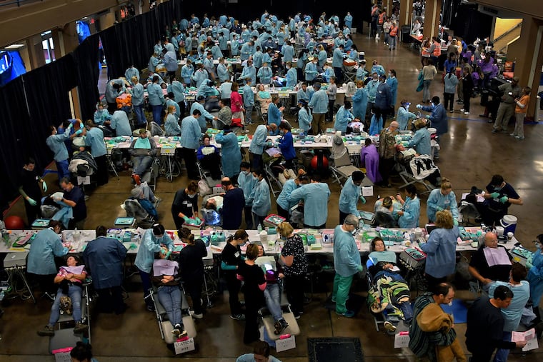 Scores of patients and dentists pair up at the Remote Area Medical free clinic in Knoxville, Tenn. The all-volunteer group delivers medical, dental and vision care services in underserved, isolated, or impoverished communities around the country and world.
