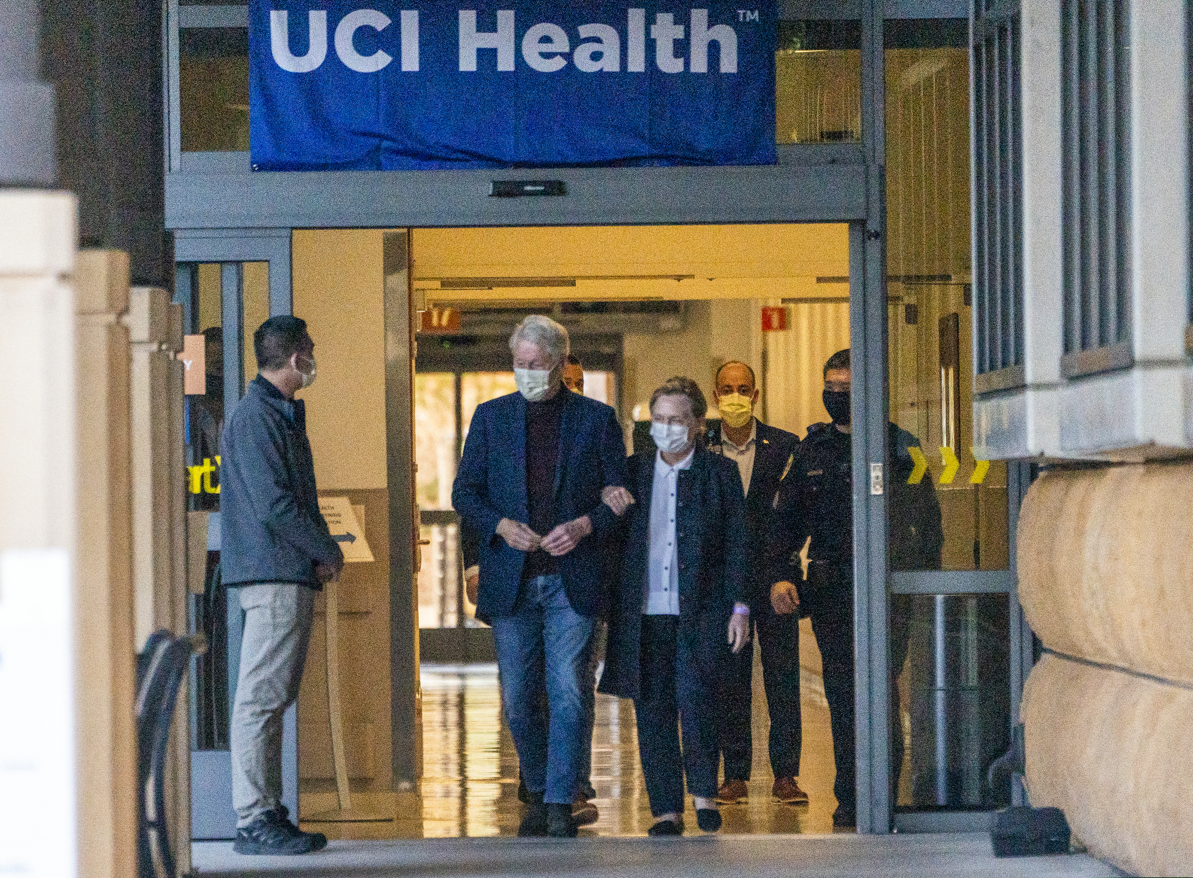 Former President Bill Clinton and former U.S. Secretary of State Hillary Clinton leave the University of California Irvine Medical Center in Orange, Calif., on Sunday.