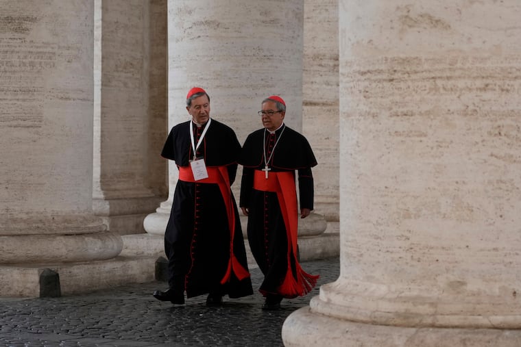 Cardinals Ruben Salazar Gomez, left, and Cardinal Luis José Rueda Aparicio arrive in the New Hall of the Synod at the Vatican on Tuesday, May 6, 2025.