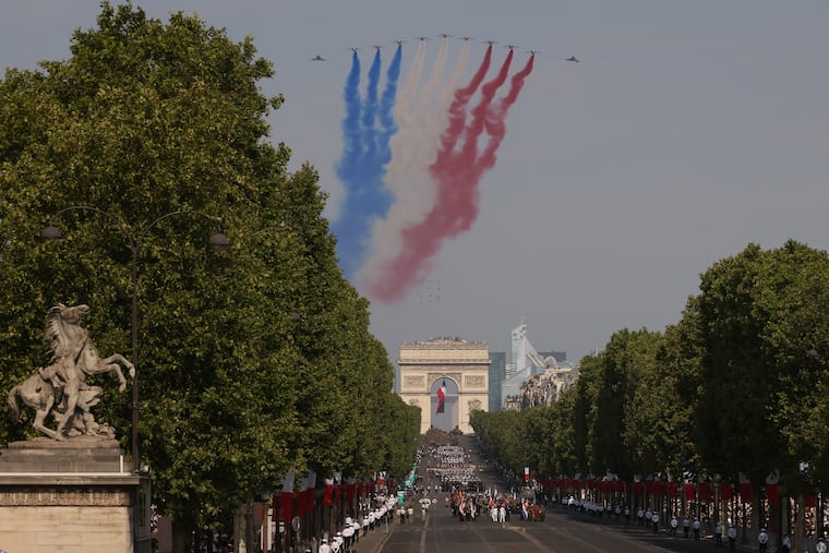 Jets from the acrobatic Patrouille de France fly during the Bastille Day military parade on the Champs-Elysees avenue in Paris, Tuesday, July 14, 2026.