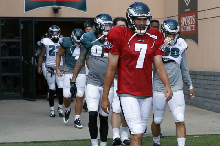 Sam Bradford leads the Eagles onto the practice field during training camp yesterday.