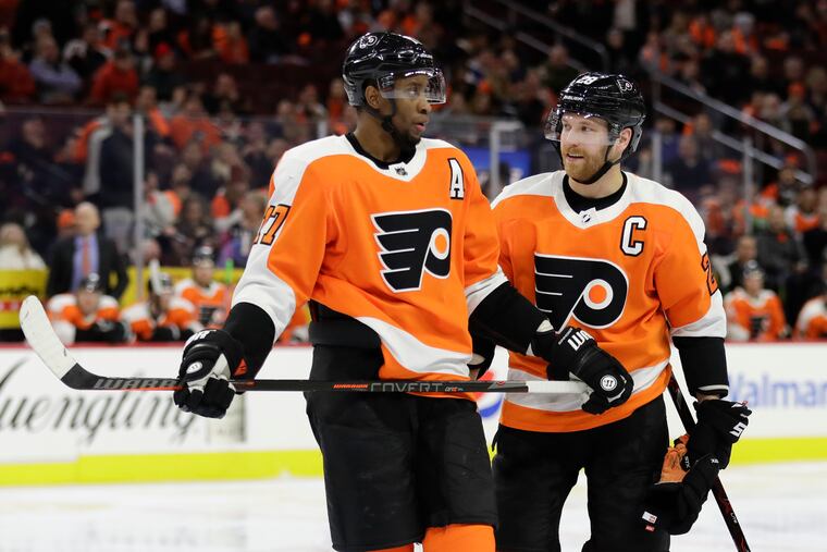 Wanting to be rested for their game Thursday, Wayne Simmonds (left) and Claude Giroux were among the Flyers who paid their own airfare and traveled to Tampa a day ahead of the team.