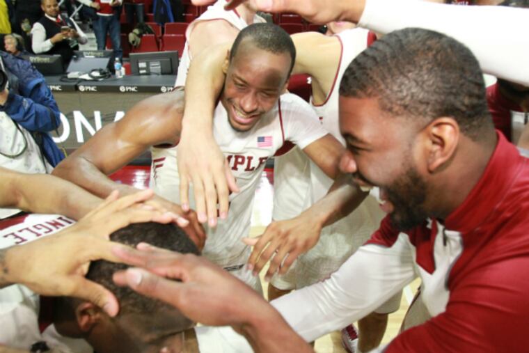 Temple players celebrate their win in the NIT quarterfinals. (Charles Fox/Staff Photographer)