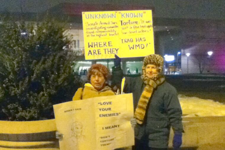 Barbara Quintiliano (left) and Ann Agee (right) were protesting in front of the National Constitution Center where Donald Rumsfeld was discussing details from his new book. (Jan Ransom / Staff)